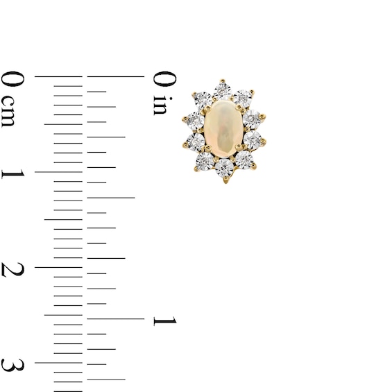 Oval Opal and 1/20 CT. T.w. Diamond Sunburst Frame Stud Earrings in 10K Gold