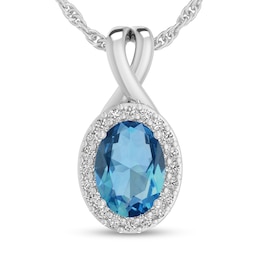Oval Swiss Blue Topaz and 1/15 CT. T.W. Diamond Frame Split Bail Pendant in 10K White Gold