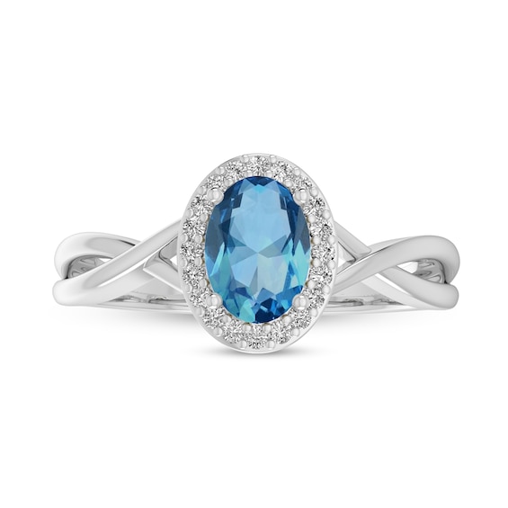 Oval Swiss Blue Topaz and 1/15 CT. T.w. Diamond Frame Crossover Shank Ring in 10K White Gold