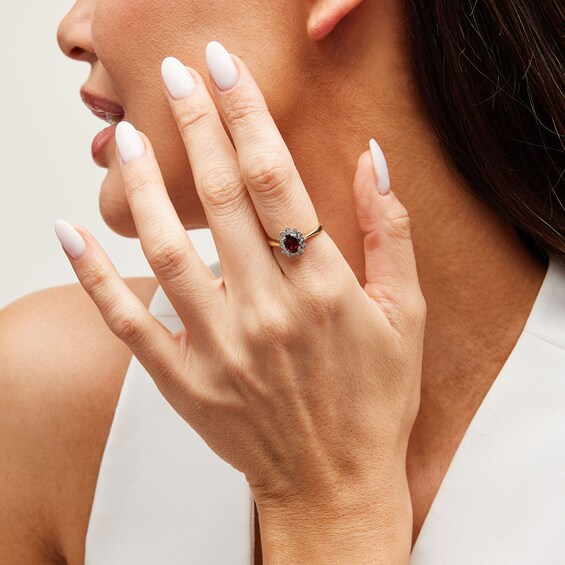 Oval Garnet and Diamond Accent Sunburst Frame Ring in 10K Gold