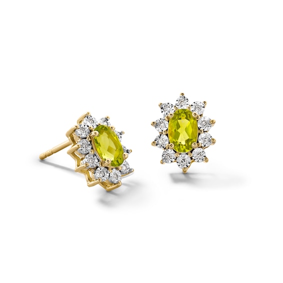 Oval Peridot and 1/20 CT. T.w. Diamond Sunburst Frame Stud Earrings in 10K Gold