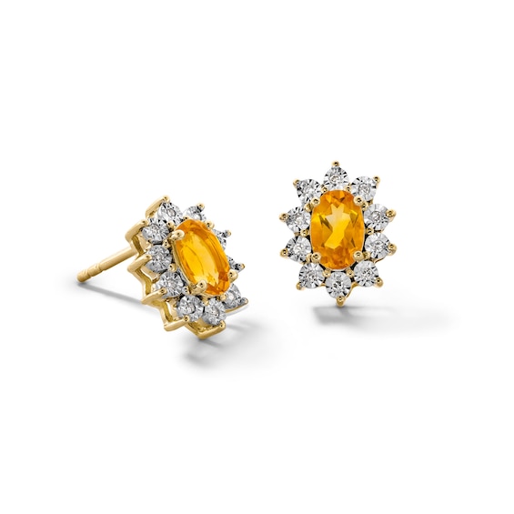 Oval Citrine and 1/20 CT. T.w. Diamond Sunburst Frame Stud Earrings in 10K Gold