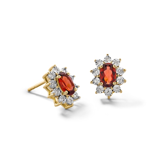 Oval Garnet and 1/20 CT. T.w. Diamond Sunburst Frame Stud Earrings in 10K Gold