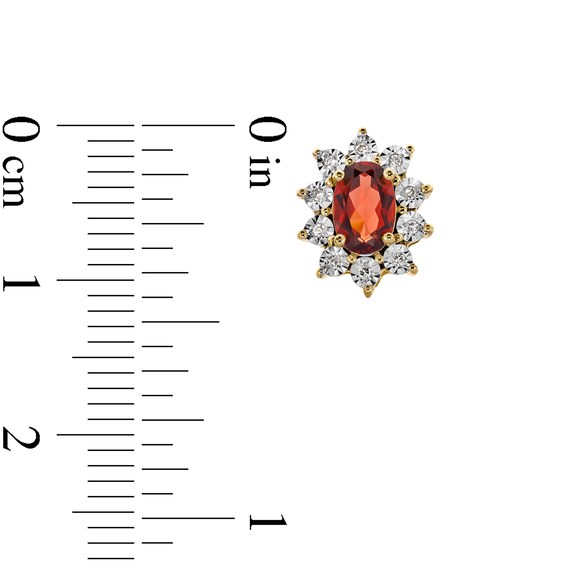 Oval Garnet and 1/20 CT. T.w. Diamond Sunburst Frame Stud Earrings in 10K Gold