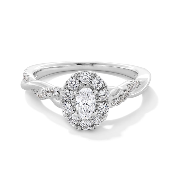 3/4 CT. T.w. Oval Diamond Frame Twist Shank Engagement Ring in 14K White Gold