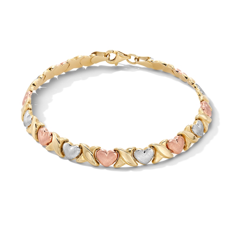 Main Image 1 of 6.25mm "XO" Heart Link Stampato Bracelet in Hollow 10K Tri-Tone Gold - 7.25"