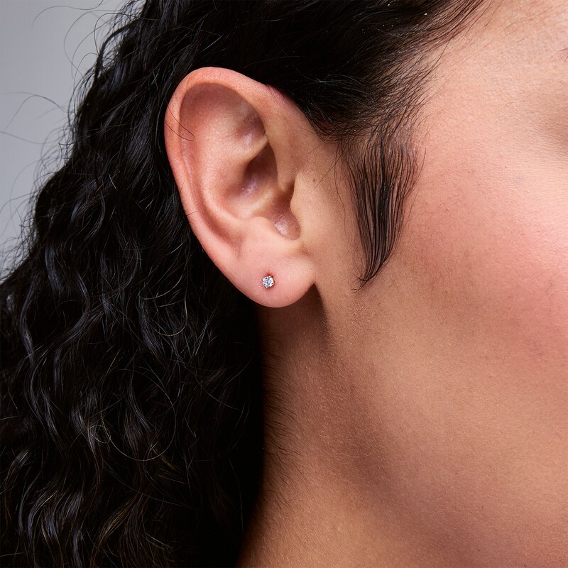 Main Image 2 of 1/10 CT. T.W. Diamond Solitaire Stud Earrings in 14K Gold (I/I2)