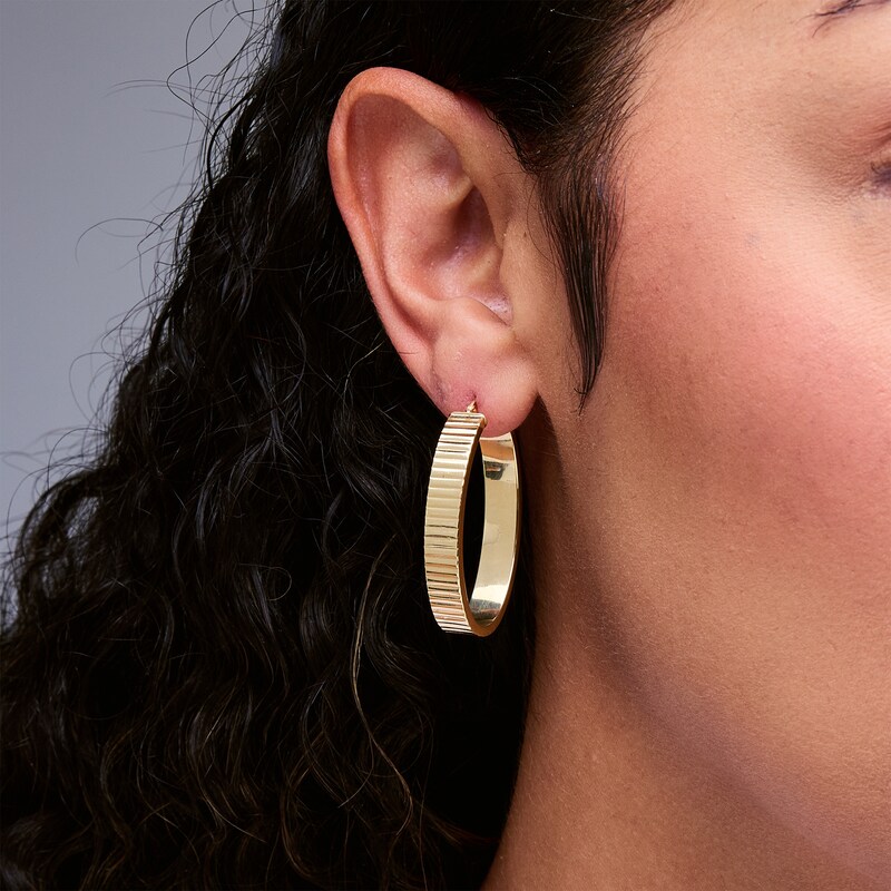 Main Image 2 of 25.0mm Diamond-Cut Ribbed Oval Hoop Earrings in Hollow 10K Gold