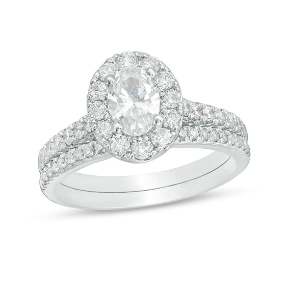 Previously Owned - Celebration Ideal 1-1/2 CT. T.w. Oval Diamond Frame Soldered Bridal Set in 14K White Gold