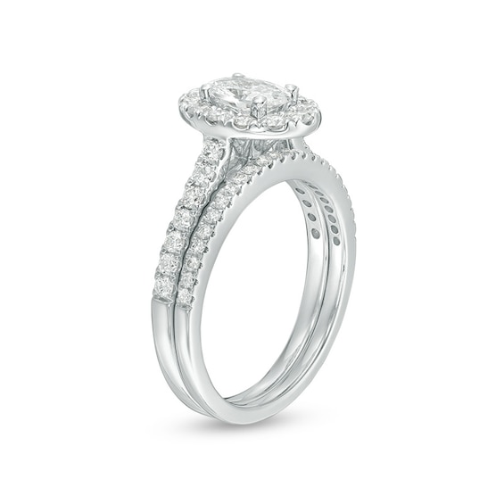 Previously Owned - Celebration Ideal 1-1/2 CT. T.w. Oval Diamond Frame Soldered Bridal Set in 14K White Gold