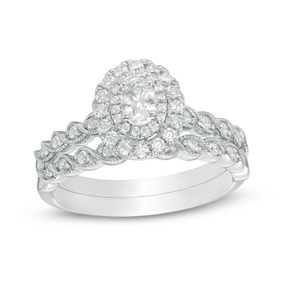 Previously Owned - 3/4 CT. T.w. Oval Diamond Double Frame Twist Vintage-Style Soldered Bridal Set in 14K White Gold