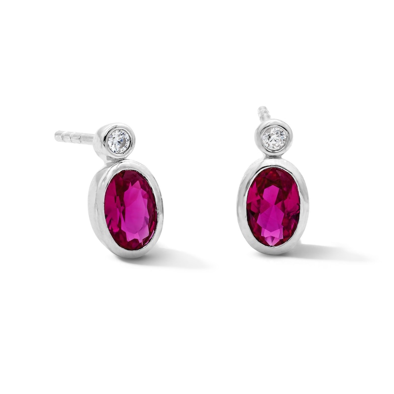 Main Image 1 of Oval Lab-Created Ruby and 1/20 CT. T.W. Lab-Grown Diamond Earrings in Sterling Silver (F/VS2)