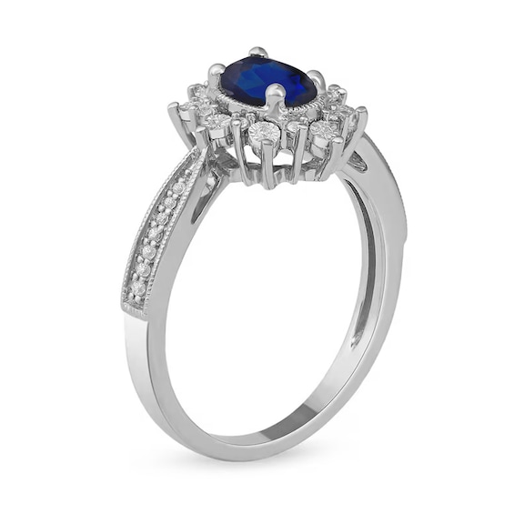Oval Blue Sapphire and 1/10 CT. T.w. Diamond Starburst Frame Ring in 10K White Gold