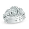 Thumbnail Image 1 of Previously Owned - 1 CT. T.W. Diamond Oval Frame Three Stone Cluster Three Piece Bridal Set in 10K White Gold