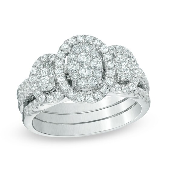 Previously Owned - 1 CT. T.w. Diamond Oval Frame Three Stone Cluster Three Piece Bridal Set in 10K White Gold