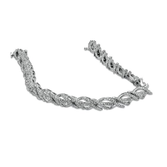 Previously Owned - 1/2 CT. T.w. Diamond Ribbon Twist Bracelet in Sterling Silver