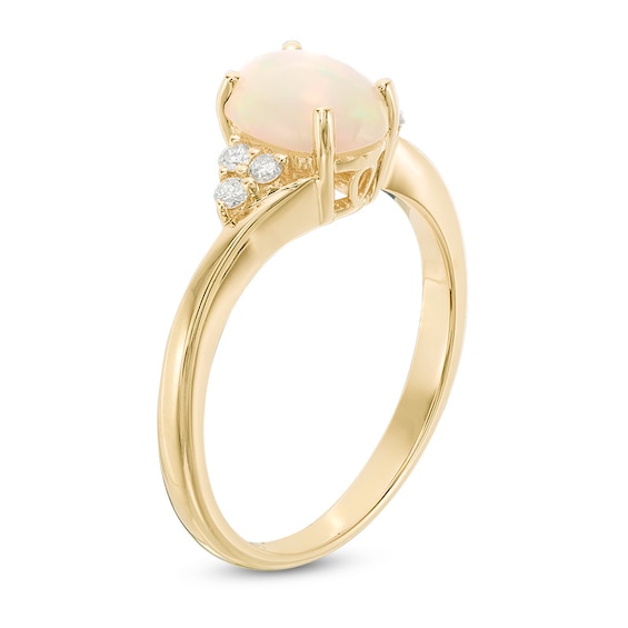 Previously Owned - Oval Opal and 1/10 CT. T.w. Diamond Tri-Sides Ring in 10K Gold