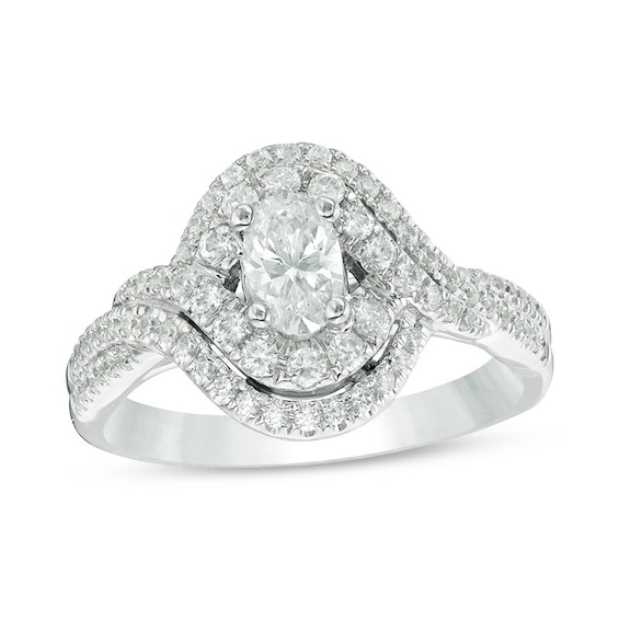 Previously Owned - Celebration Ideal 1 CT. T.w. Oval Diamond Bypass Frame Engagement Ring in 14K White Gold (I/I1)