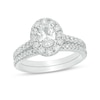 Thumbnail Image 1 of Previously Owned - Celebration Ideal 1-1/2 CT. T.W. Oval Diamond Frame Bridal Set in 14K White Gold (I/I1)