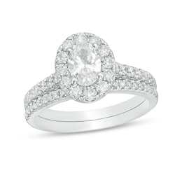 Previously Owned - Celebration Ideal 1-1/2 CT. T.W. Oval Diamond Frame Bridal Set in 14K White Gold (I/I1)