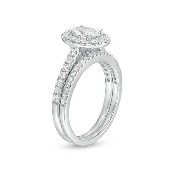 Previously Owned - Celebration Ideal 1-1/2 CT. T.w. Oval Diamond Frame Bridal Set in 14K White Gold (I/I1)
