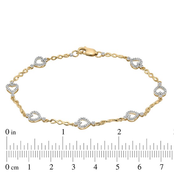 Previously Owned - 1/10 CT. T.w. Diamond Sideways Heart Station Twist Bracelet in 10K Gold - 7.5"