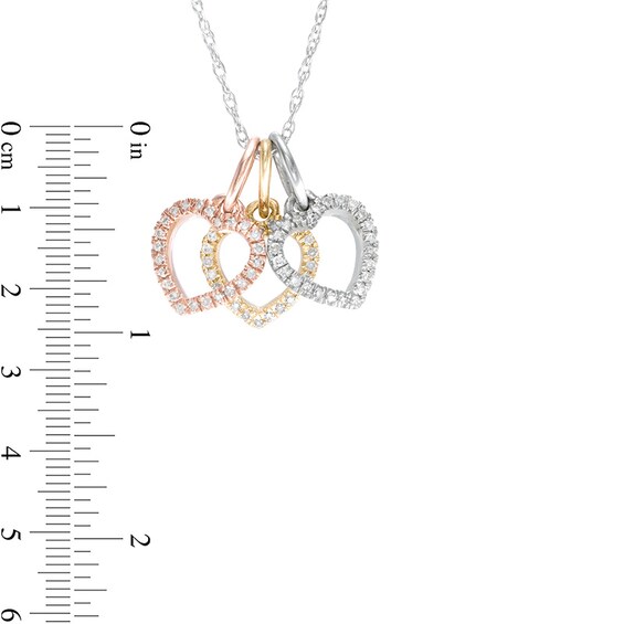 Previously Owned - 1/10 CT. T.w. Diamond Triple Heart Pendant in 10K Tri-Tone Gold