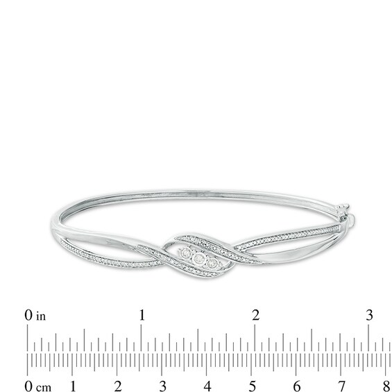 Previously Owned - 1/5 CT. T.w. Diamond Three Stone Bypass Ribbon Bangle in Sterling Silver
