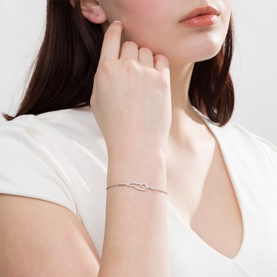 Previously Owned - 1/20 CT. T.w. Diamond Sideways Angel Wing Bolo Bracelet in Sterling Silver - 9.5"
