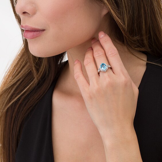 Previously Owned - Oval Swiss Blue Topaz and Lab-Created White Sapphire Flower Petal Frame Ring in Sterling Silver