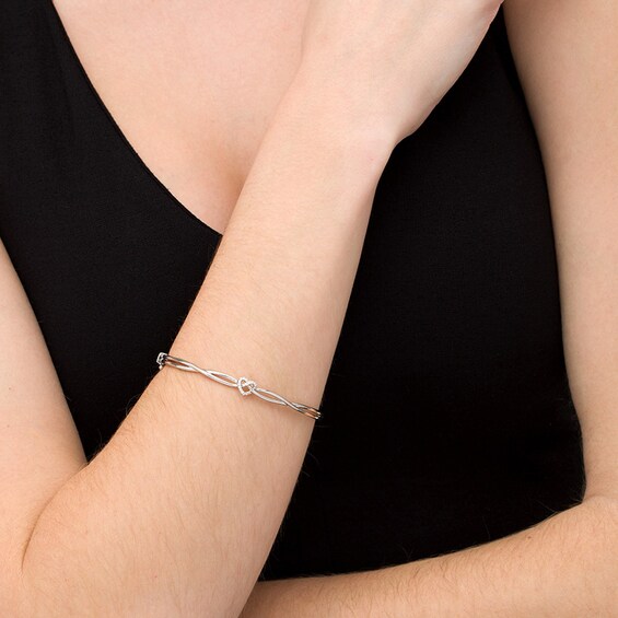 Previously Owned - 1/10 CT. T.w. Diamond Heart Knot Bangle in Sterling Silver