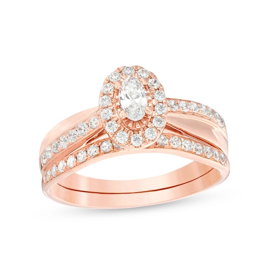 Previously Owned - 3/4 CT. T.w. Oval Diamond Frame Crossover Bridal Set in 14K Rose Gold