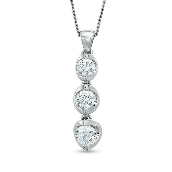 Previously Owned - 1/2 CT. T.w. Diamond Three Stone Tension-Set Pendant in 14K White Gold (I/I2) - 17"