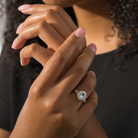 Previously Owned - Oval Aquamarine and 1/4 CT. T.w. Diamond Flower Frame Vintage-Style Ring in 14K White Gold