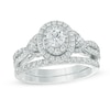 Thumbnail Image 1 of Previously Owned - Celebration Ideal 1-1/5 CT. T.W. Diamond Layered Oval Frame Crossover Bridal Set in 14K White Gold