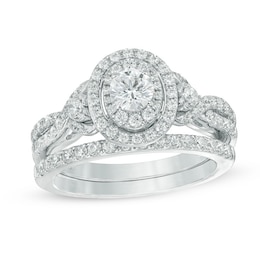 Previously Owned - Celebration Ideal 1-1/5 CT. T.W. Diamond Layered Oval Frame Crossover Bridal Set in 14K White Gold