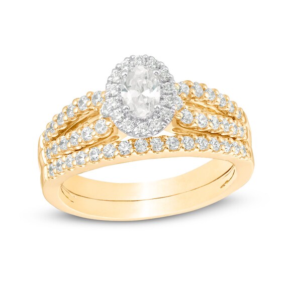Previously Owned - 1 CT. T.w. Oval Diamond Frame Split Shank Bridal Set in 14K Gold (I/I1)