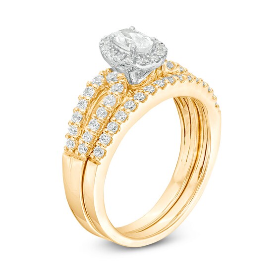 Previously Owned - 1 CT. T.w. Oval Diamond Frame Split Shank Bridal Set in 14K Gold (I/I1)
