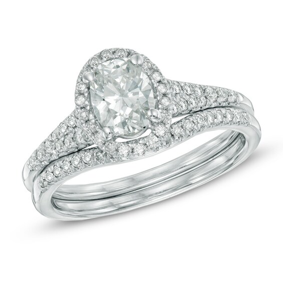 Previously Owned - 1-1/6 CT. T.w. Oval Diamond Frame Bridal Set in 14K White Gold