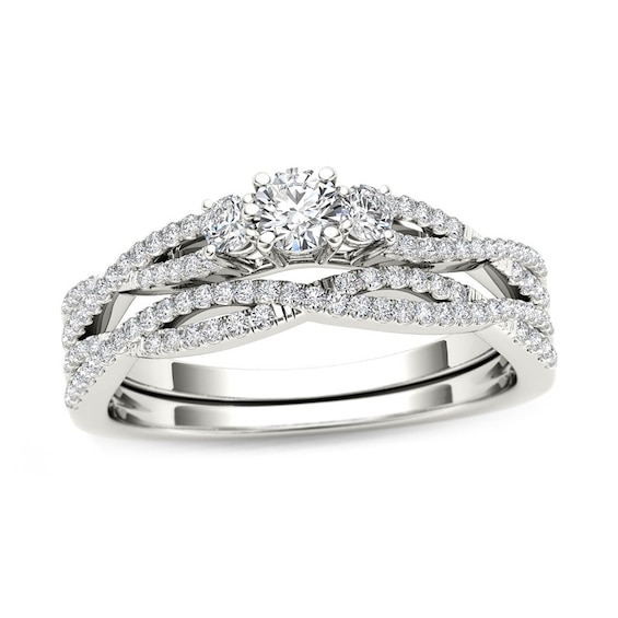 Previously Owned - 1/2 CT. T.w. Diamond Three Stone Twist Bridal Set in 14K White Gold