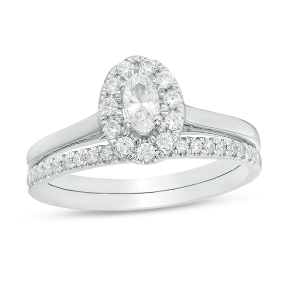 Previously Owned - 5/8 CT. T.w. Oval Diamond Frame Bridal Set in 14K White Gold