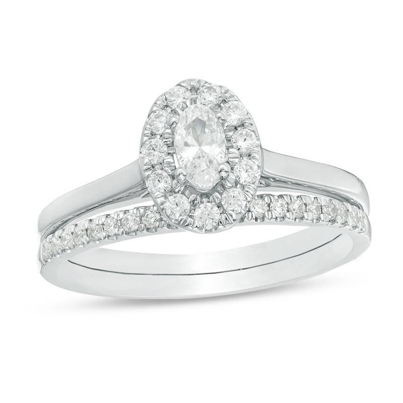 Main Image 1 of Previously Owned - 5/8 CT. T.W. Oval Diamond Frame Bridal Set in 14K White Gold