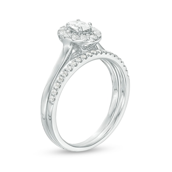 Previously Owned - 5/8 CT. T.w. Oval Diamond Frame Bridal Set in 14K White Gold