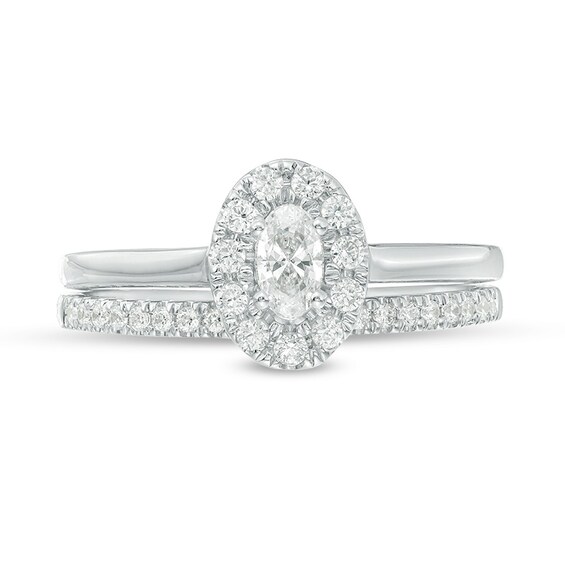 Previously Owned - 5/8 CT. T.w. Oval Diamond Frame Bridal Set in 14K White Gold