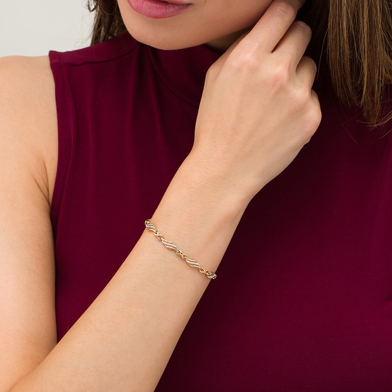 Main Image 2 of Previously Owned - 1/4 CT. T.W. Diamond Alternating Infinity Bracelet in 10K Gold – 7.5"