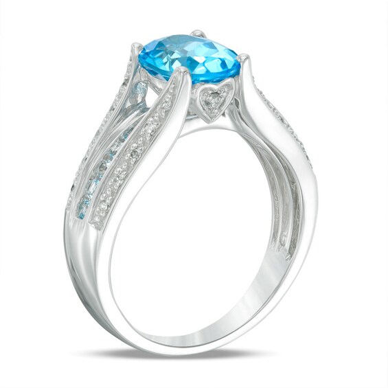 Previously Owned - Oval Swiss Blue Topaz and 1/10 CT. T.w. Diamond Triple Row Cathedral Ring in 10K White Gold