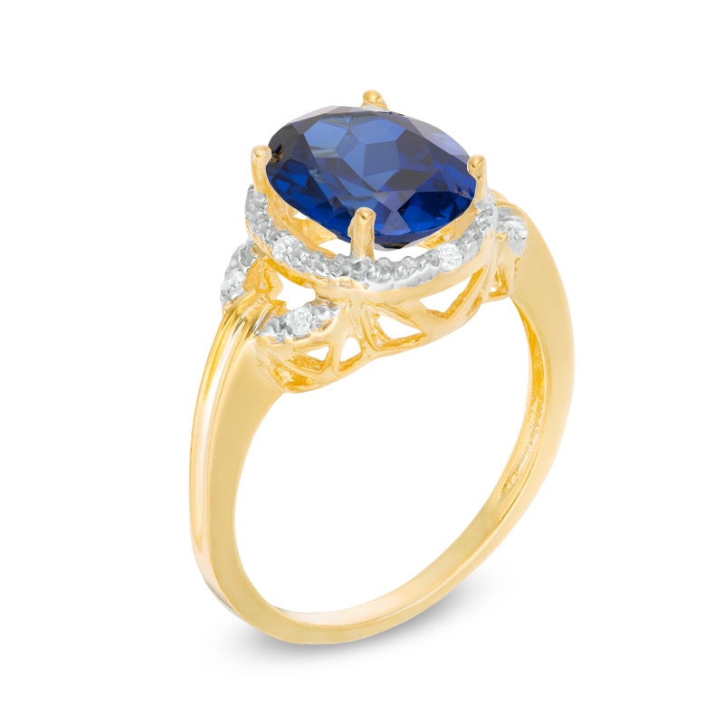 Main Image 2 of Previously Owned - Oval Lab-Created Blue Sapphire and 1/20 CT. T.W. Diamond Frame Buckle Ring in 10K Gold