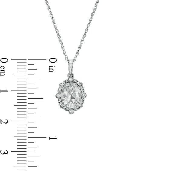 Previously Owned - Oval White Lab-Created Sapphire and 1/10 CT. T.w. Diamond Ornate Frame Pendant in 10K White Gold