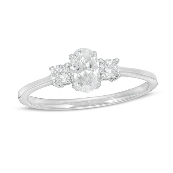 Previously Owned - 5/8 CT. T.w. Oval and Round Diamond Three Stone Engagement Ring in 14K White Gold