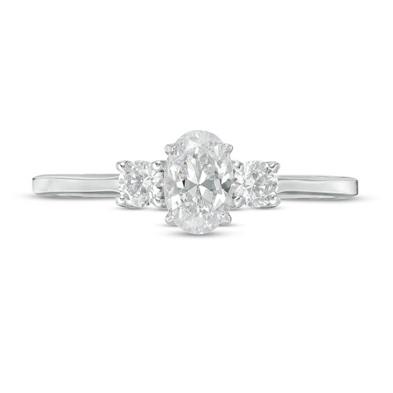 Previously Owned - 5/8 CT. T.w. Oval and Round Diamond Three Stone Engagement Ring in 14K White Gold